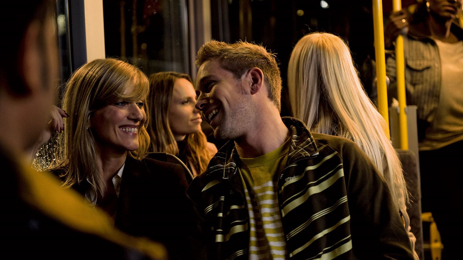 Young people on board a night bus.