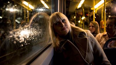 A young woman on board a Postbus.