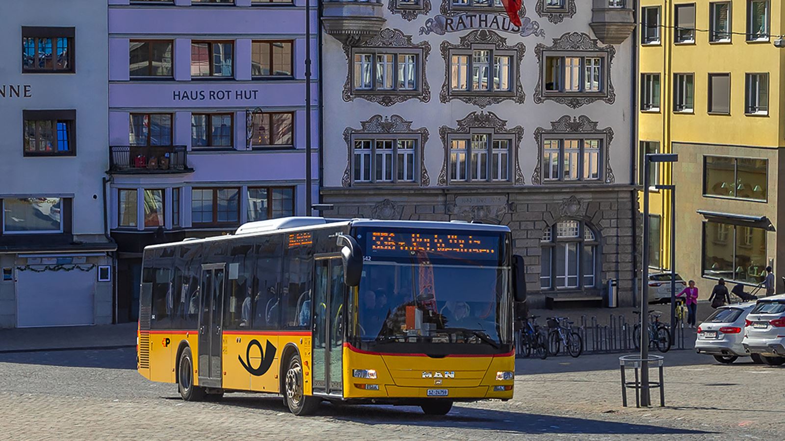 Postbus travelling on the main road in Einsiedeln in the direction of Einsiedeln Abbey
