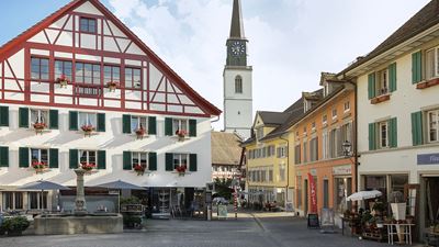View of the old town of Bülach with a church and half-timbered house.