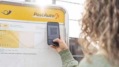 Scanning a QR code at a Postbus stop