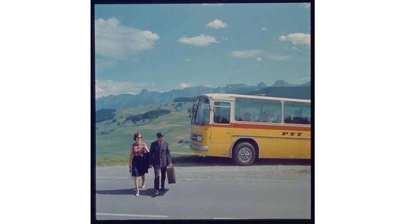 An old PostBus and a married couple